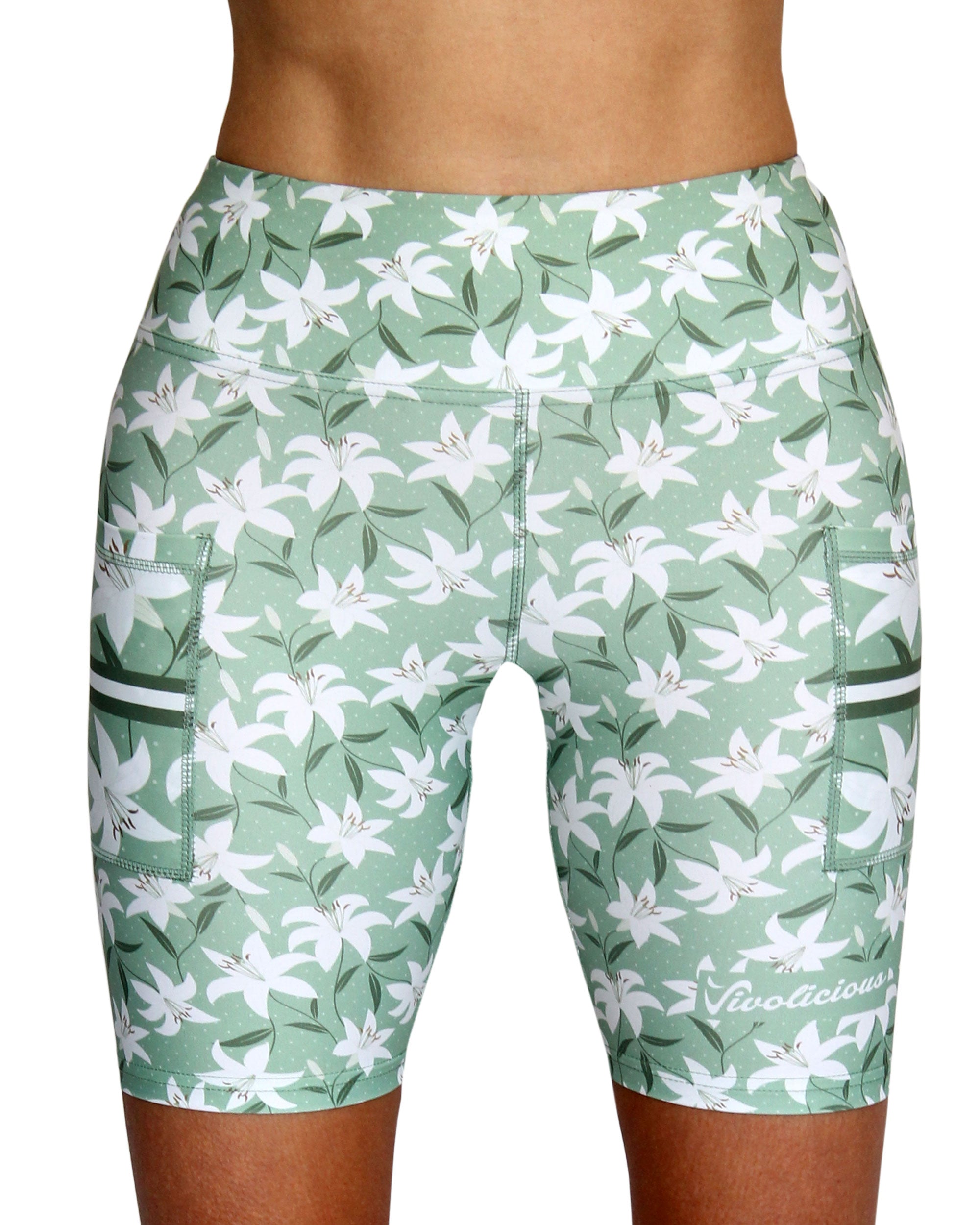 green athletic shorts with white floral pattern 